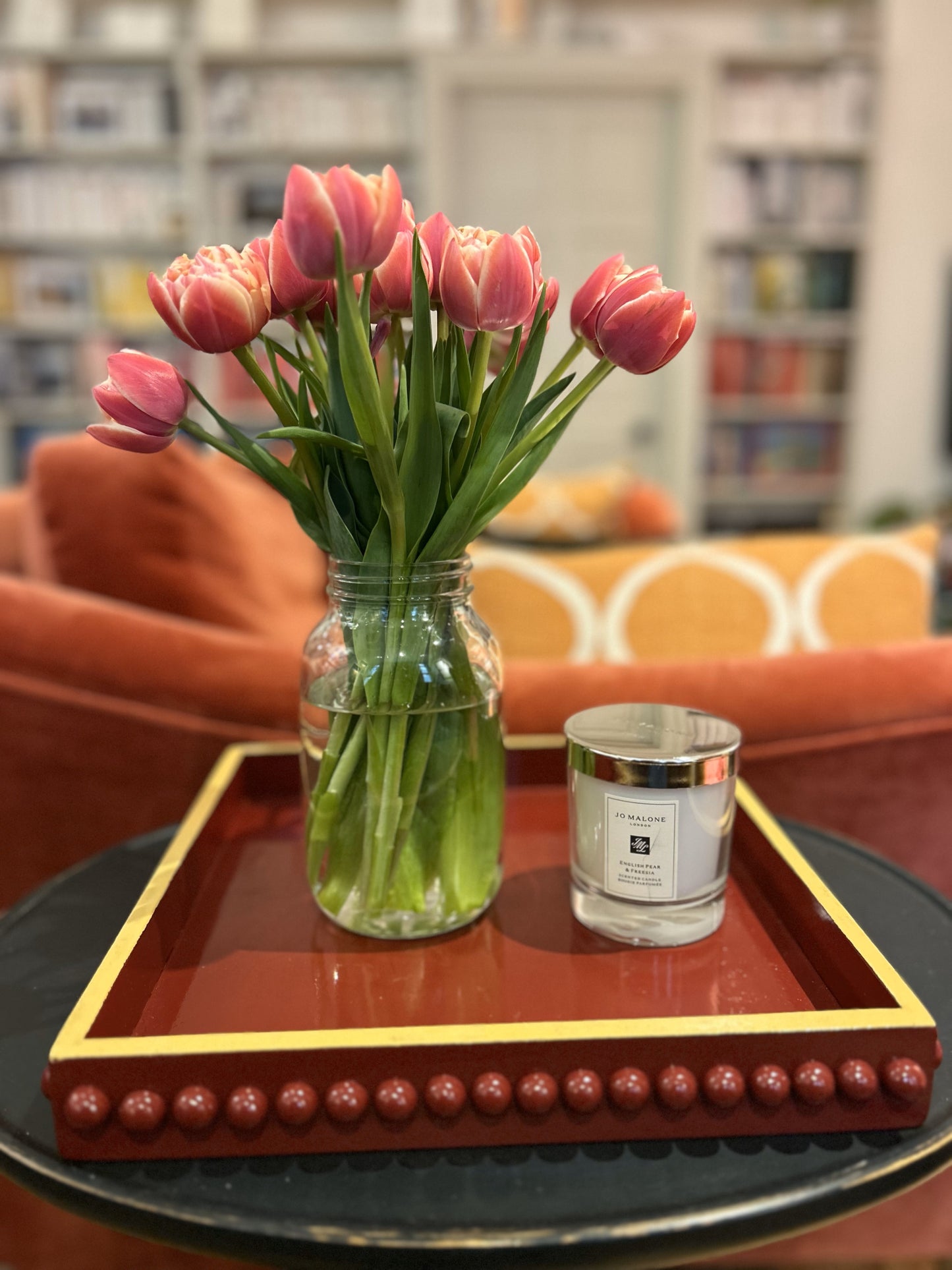 A hand painted square decorative coffee table tray with a dark red bobbin style pattern and mustard edge, gloss finish.