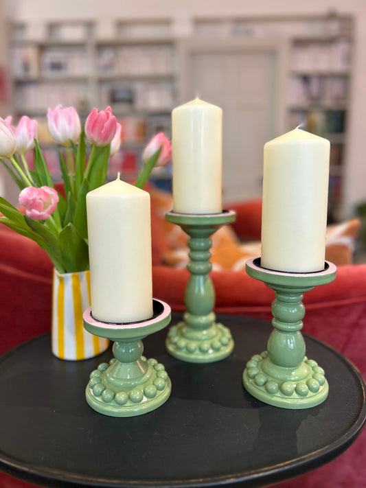 Green and pink pillar candle holder with bobbins 