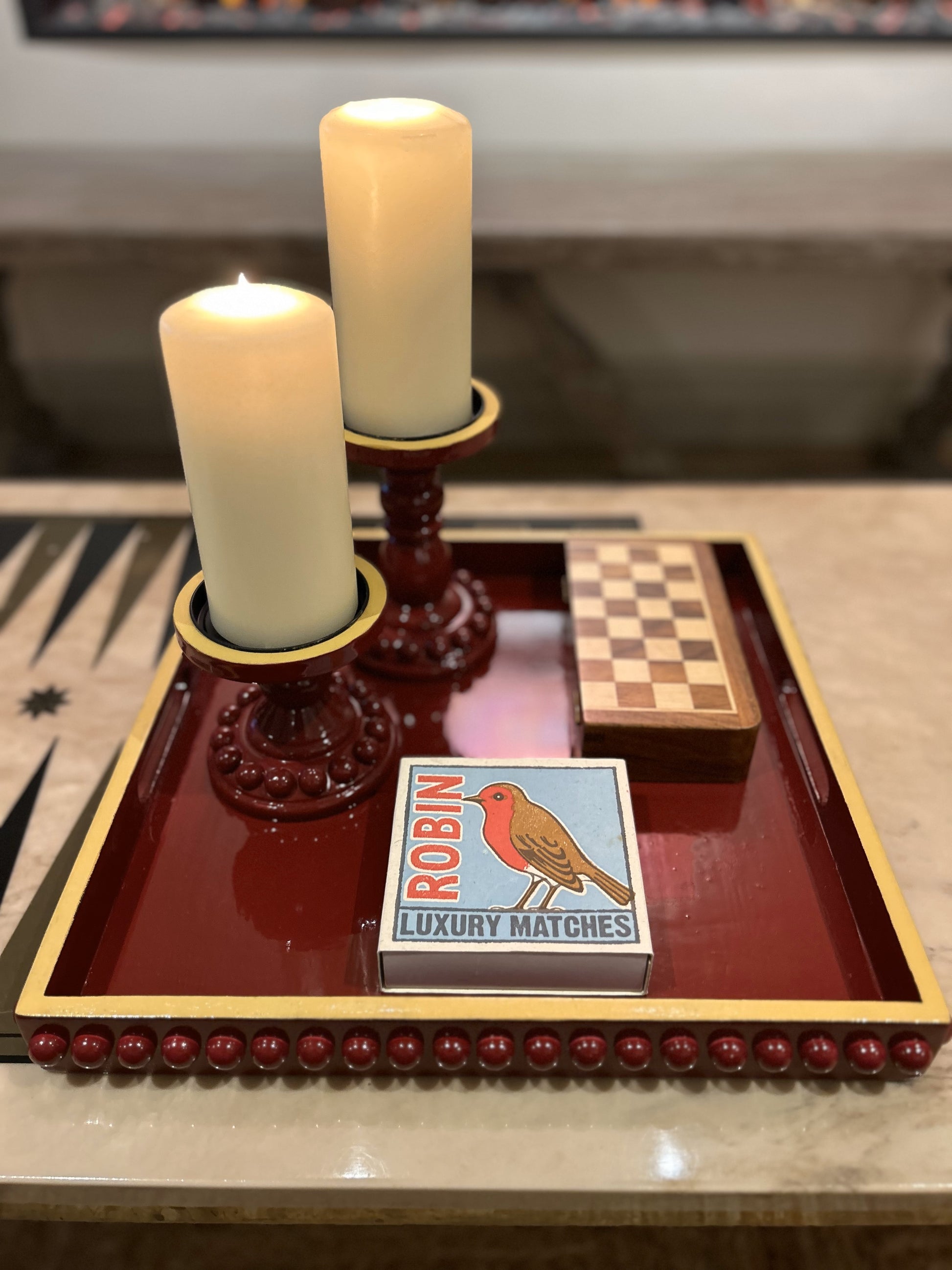 A hand painted square decorative coffee table tray with a dark red bobbin style pattern and mustard edge, gloss finish. 